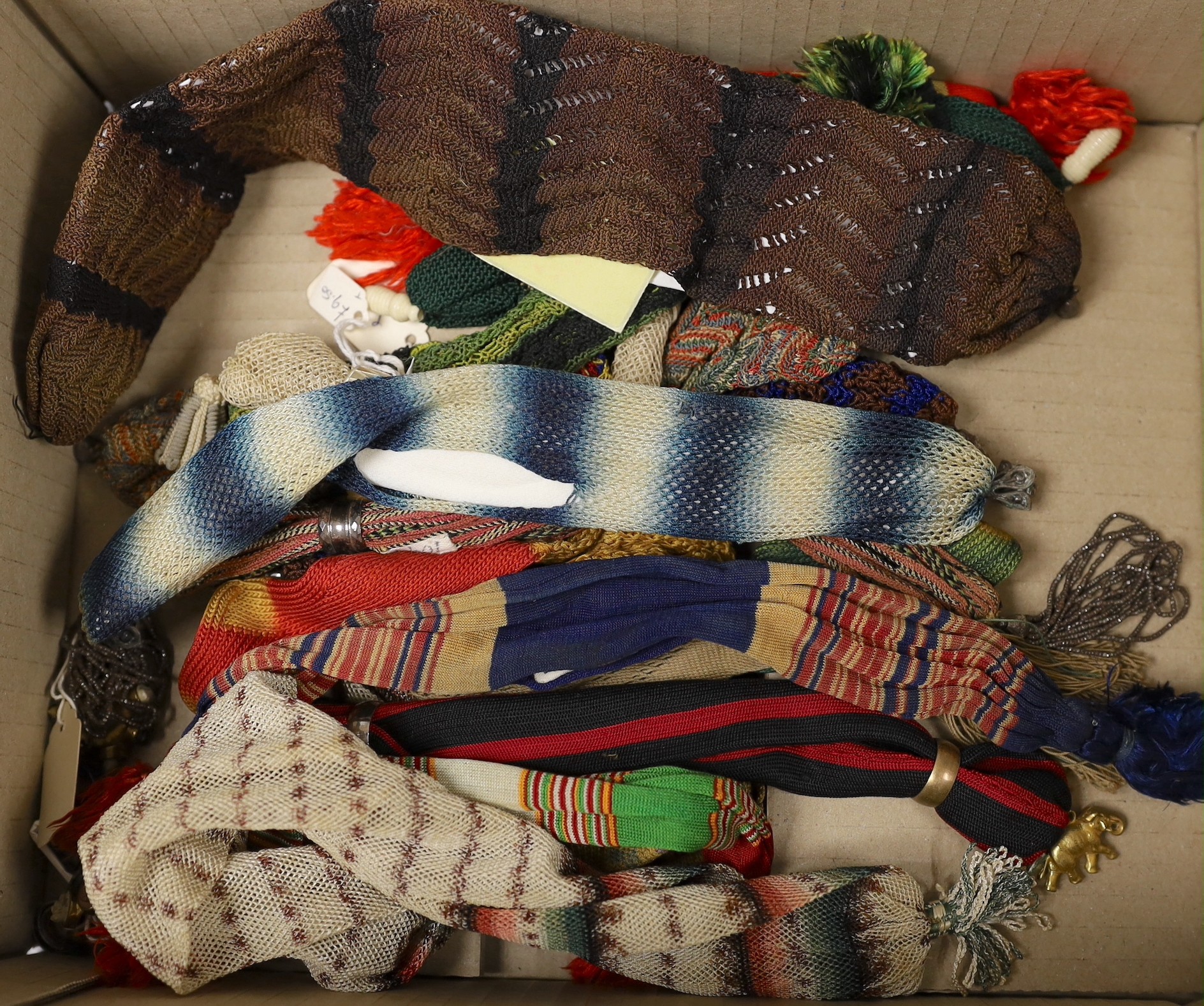 Sixteen mixed knitted misers purses, 19th century, some with Fairisle design, striped, and one novelty purse designed as a sock